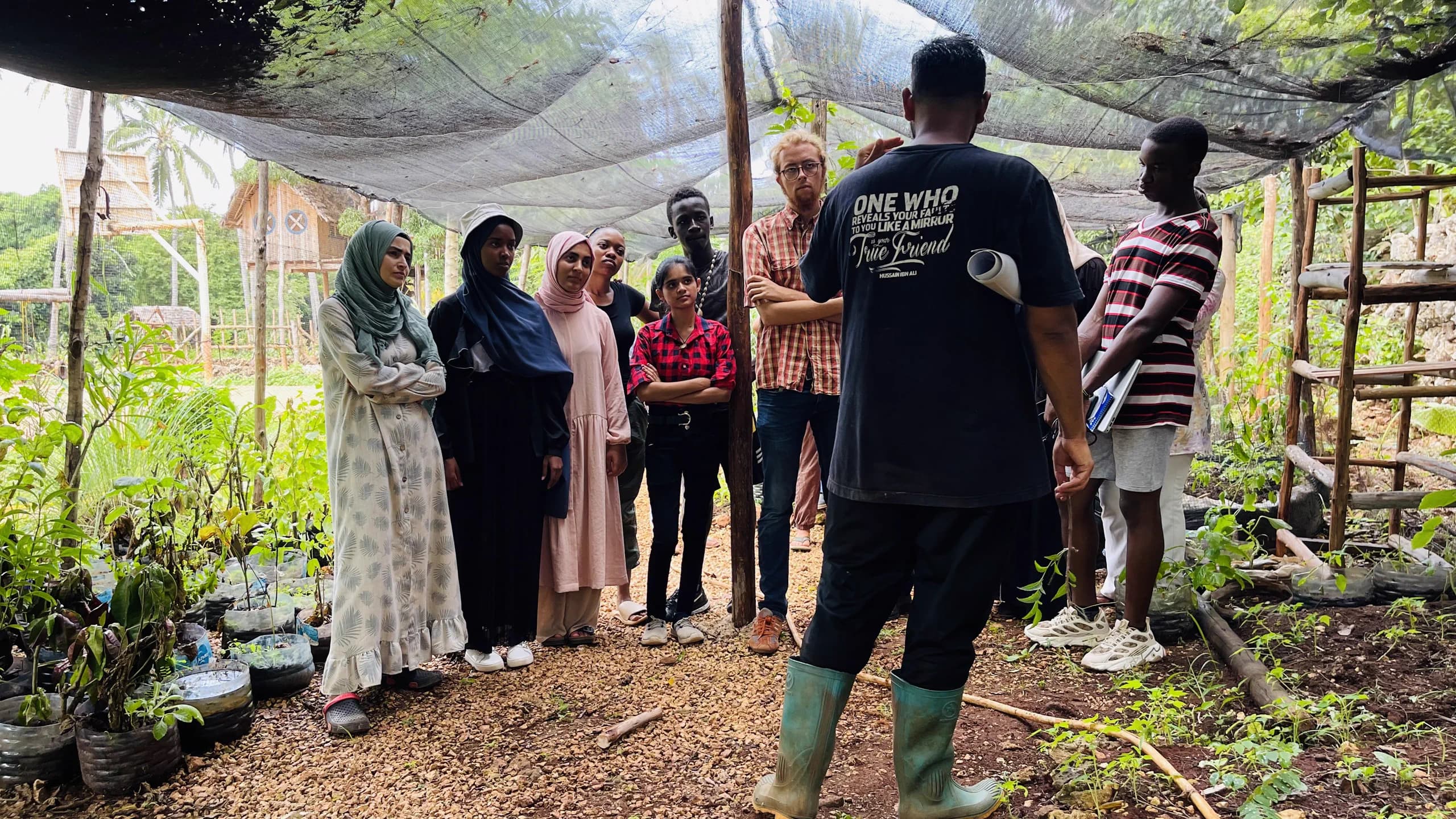 Community members sharing practical learning in a plant nursery