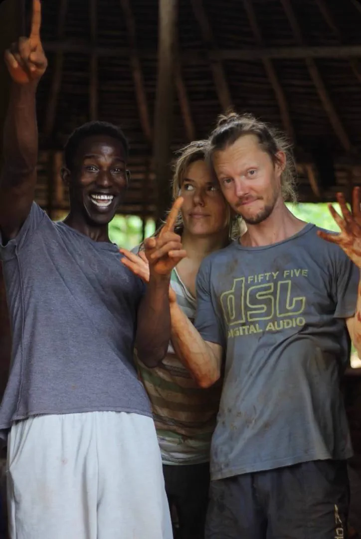 Earth House participants standing together beneath the Makuti canopy