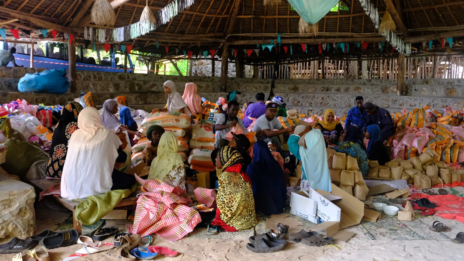 Community members preparing food and essential supplies together at Assalam