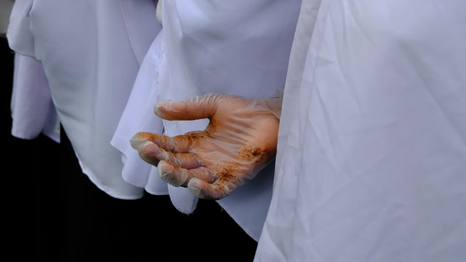 Student showing soil on a hand after planting