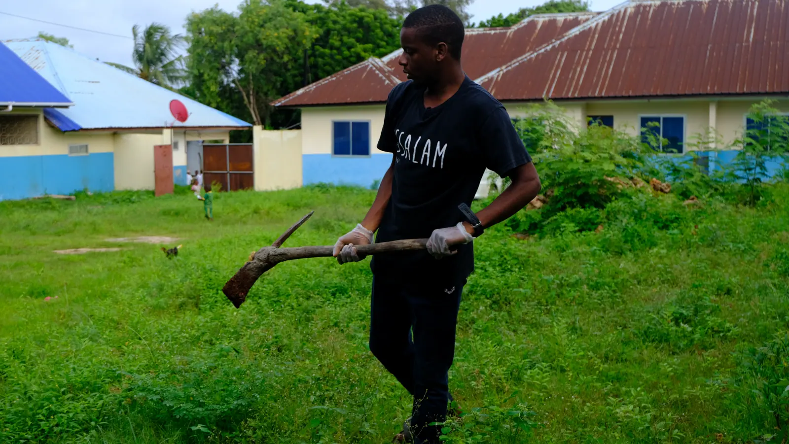 Assalam team member cultivating a green campus plot