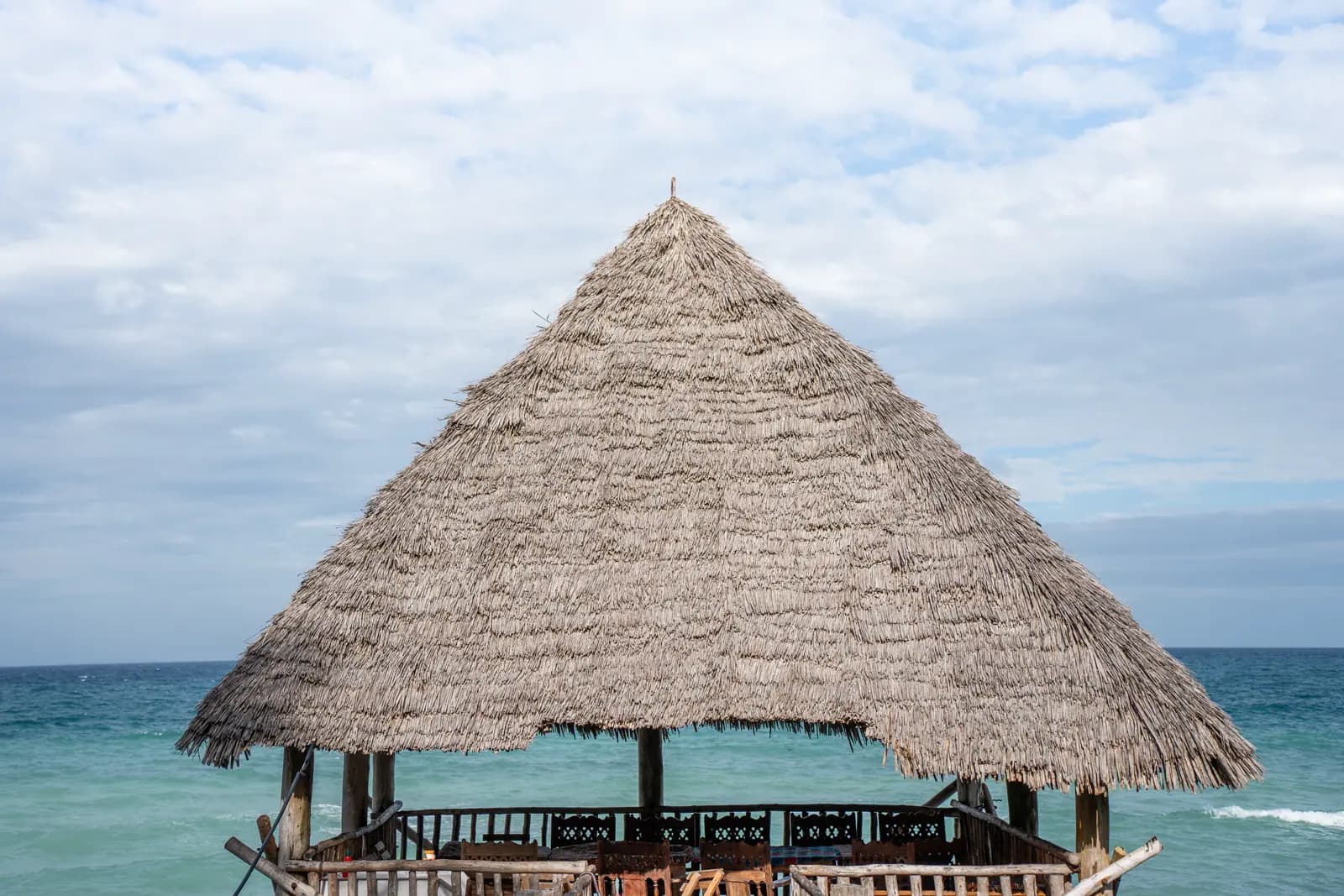 Steep Makuti pavilion roof beside the Indian Ocean